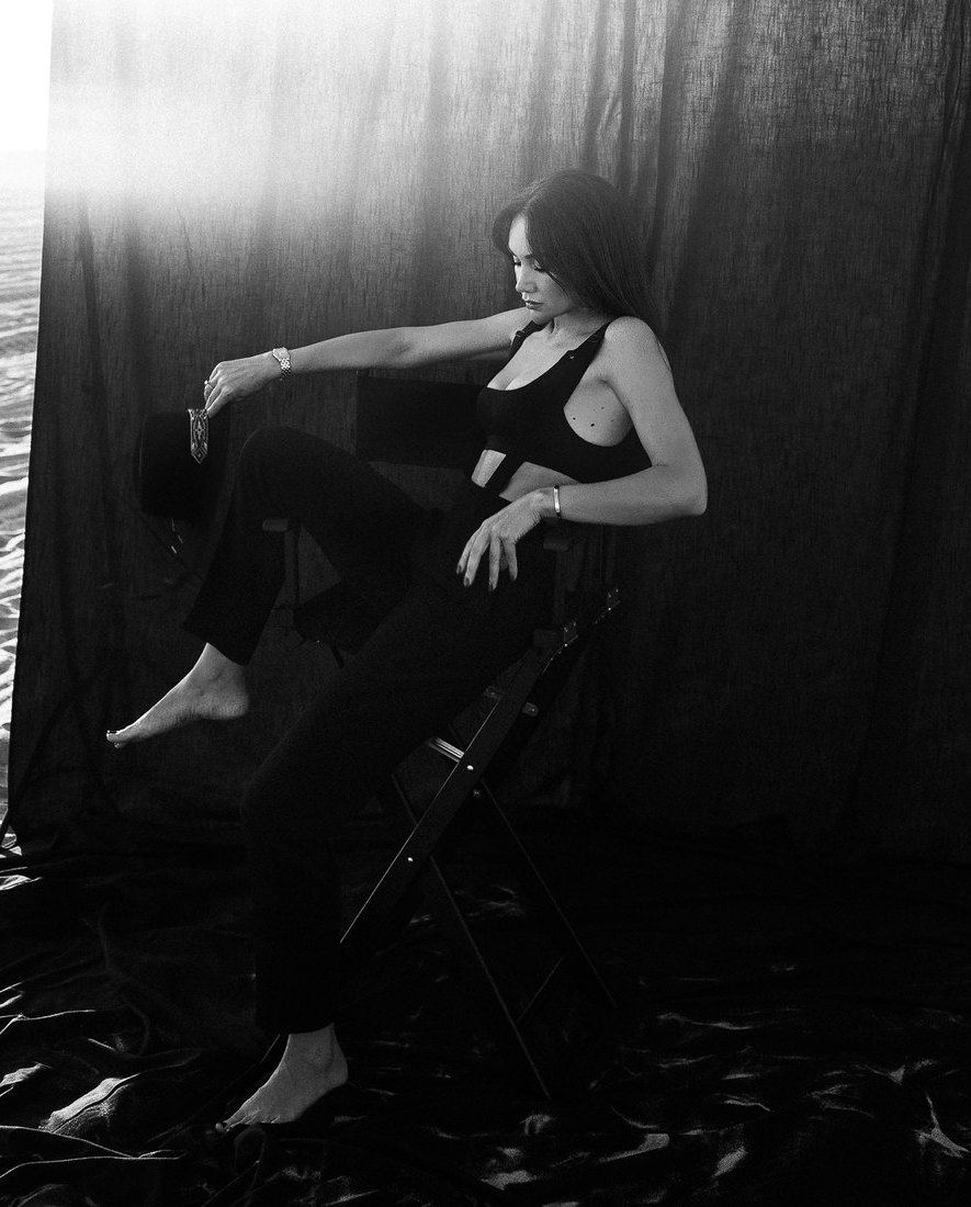 Portrait of Indre seated in a moody studio setting